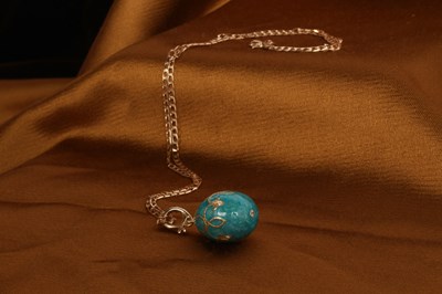 Lot 33 - An enamel egg pendant, on a 9 carat yellow...
