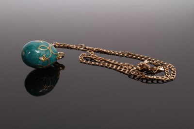 Lot 33 - An enamel egg pendant, on a 9 carat yellow...