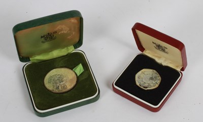 Lot 142 - Two Royal Mint commemorative coins, to include...