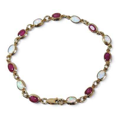 Lot 84 - An 18 carat gold, opal and garnet bracelet,...