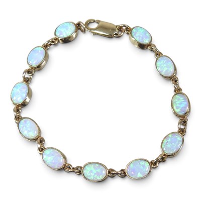 Lot 20 - A 9 carat gold and opal flexible link bracelet,...