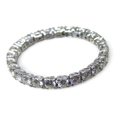 Lot 95 - An 18 carat white gold and diamond full hoop...