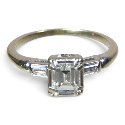 Lot 19 - A 14 carat white gold emerald cut diamond ring,...