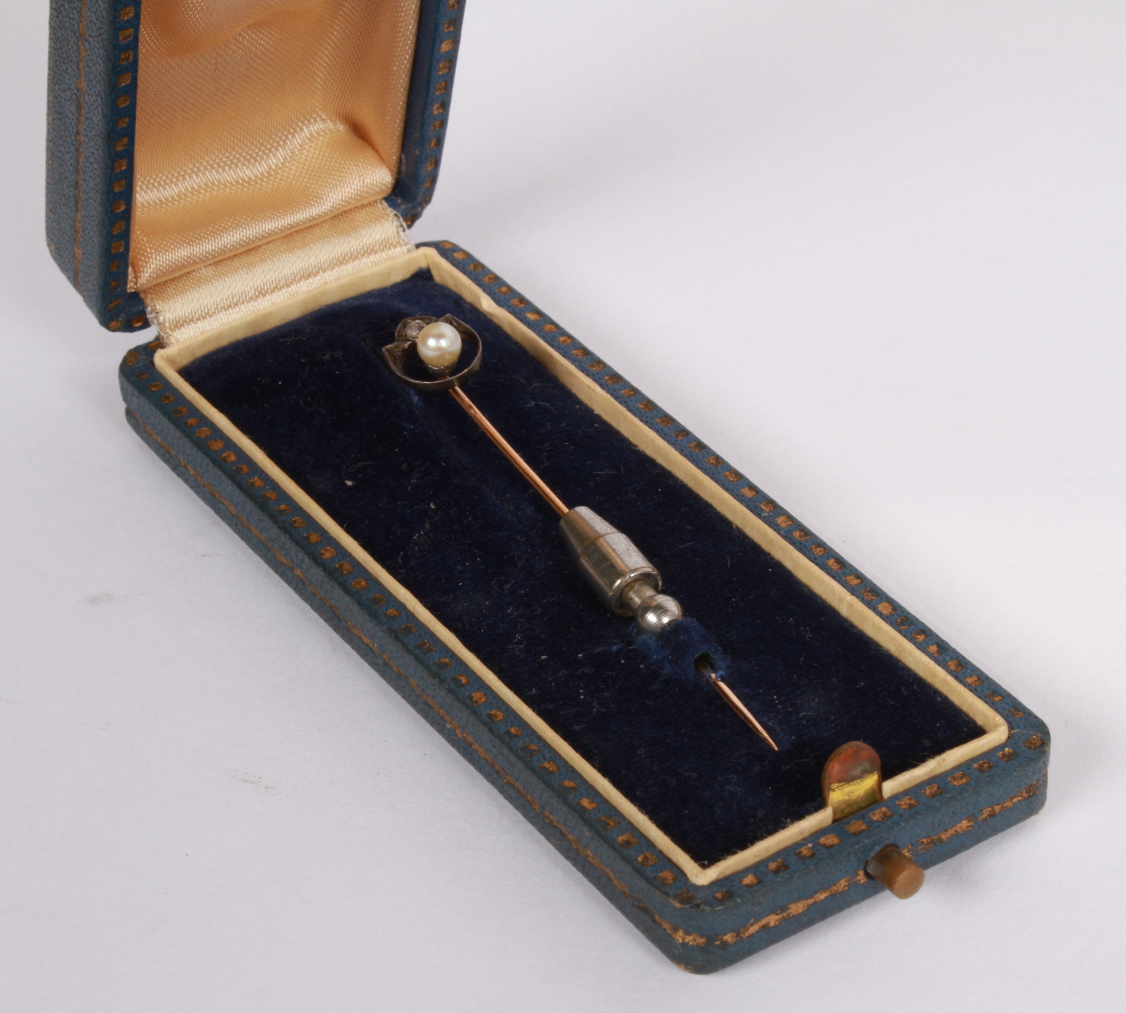Lot 98 - A yellow metal stick pin with a diamond and