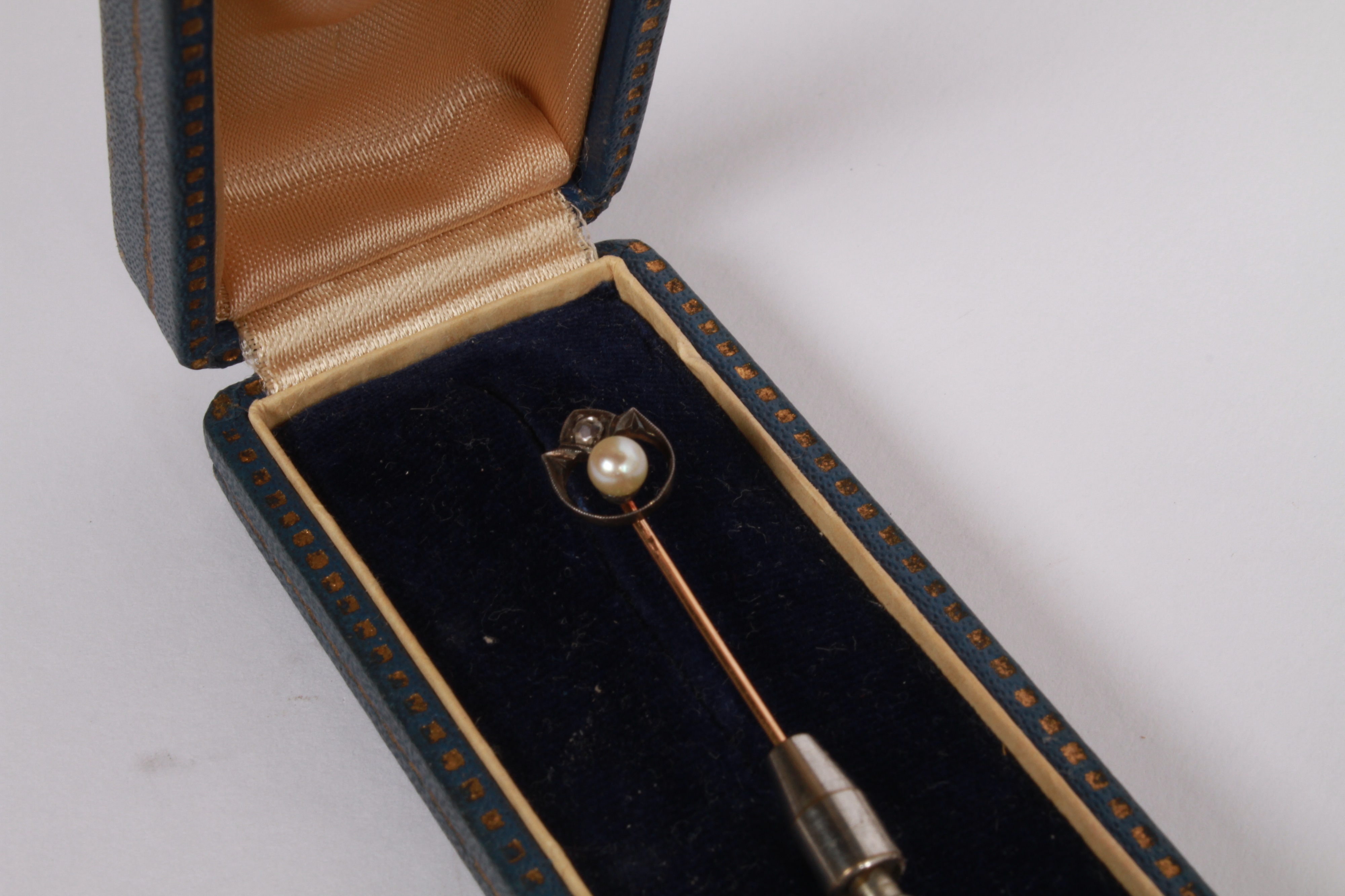 Lot 98 - A yellow metal stick pin with a diamond and