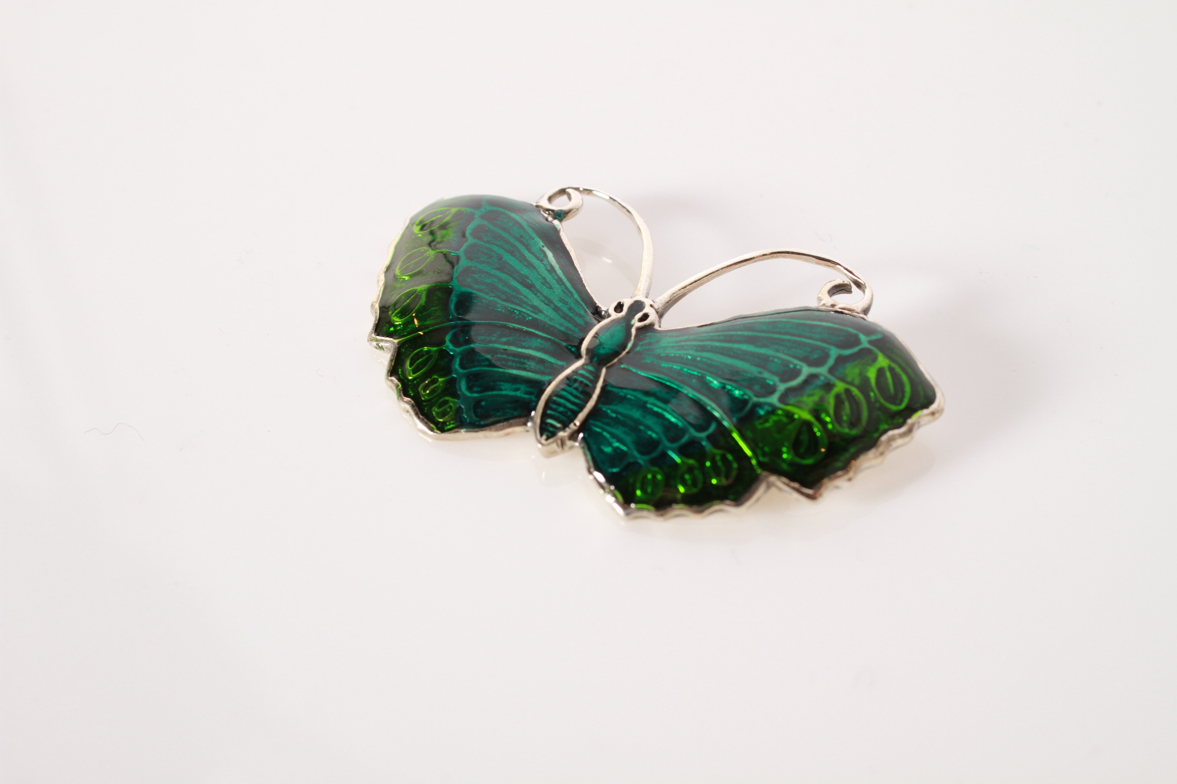 Lot 125 - A silver and green enamel butterfly brooch
