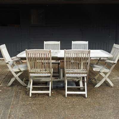 Lot 363 - A teak slatted extending garden table