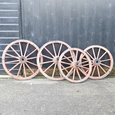 Lot 27 - A pair of red painted wooden cartwheels