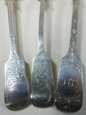 Lot 46 - A collection of George III bright cut silver table spoons