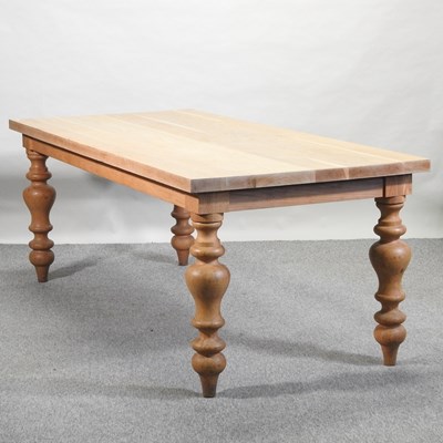 Lot 470 - A light oak dining table