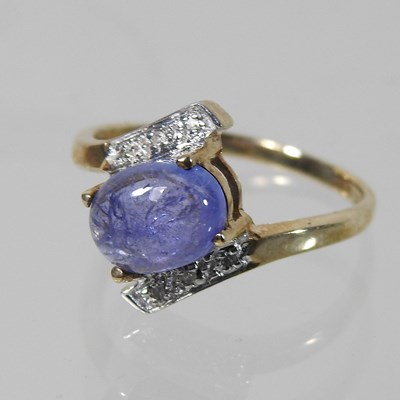 Lot 170 - A 9 carat gold diamond crossover cabochon dress ring