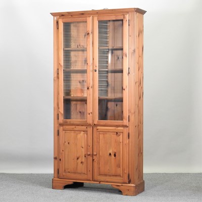 Lot 45 - A modern pine cabinet bookcase