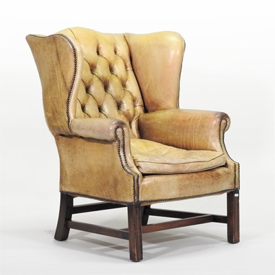 Lot 28 - A Georgian style leather upholstered wing armchair