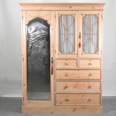 Lot 63 - An Edwardian stripped pine combination wardrobe