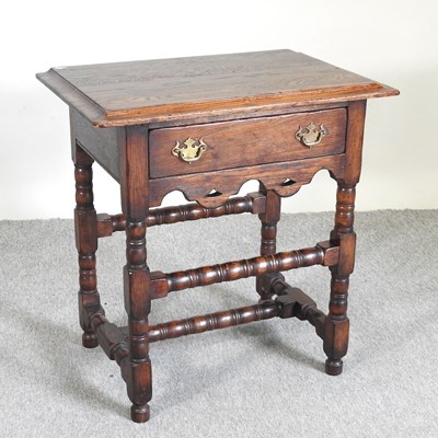 Lot 618 - An 18th century style oak lowboy