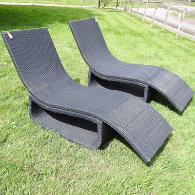 Lot 311 - A pair of rattan sun loungers